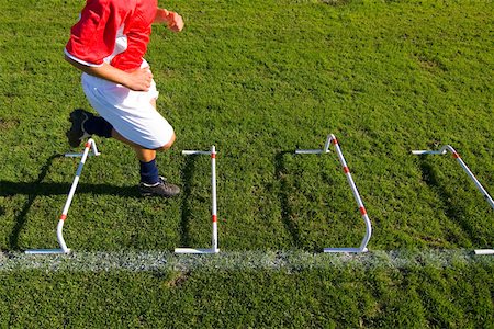 speed training drills for football - Boy running through an obstacle Stock Photo - Premium Royalty-Free, Code: 622-01283778