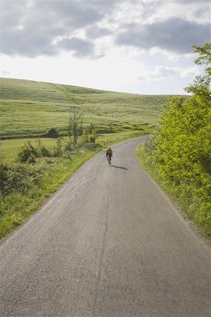 simsearch:858-03049523,k - Cyclist on road through hills Stock Photo - Premium Royalty-Free, Code: 622-02198541