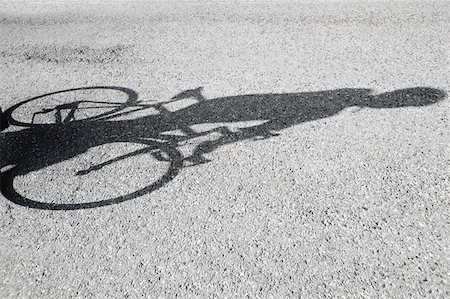 figures in shadows - Shadow of a bicyclist casting on road Stock Photo - Premium Royalty-Free, Code: 622-02198559