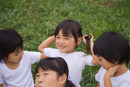 simsearch:622-02354172,k - Children sitting in park together Stock Photo - Premium Royalty-Free, Code: 622-02354147