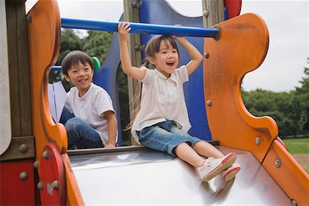 playground friends - Children playing on slide in a park Stock Photo - Premium Royalty-Free, Code: 622-02354162