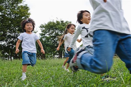 people running grass park - Children enjoying in a park Stock Photo - Premium Royalty-Free, Code: 622-02354241