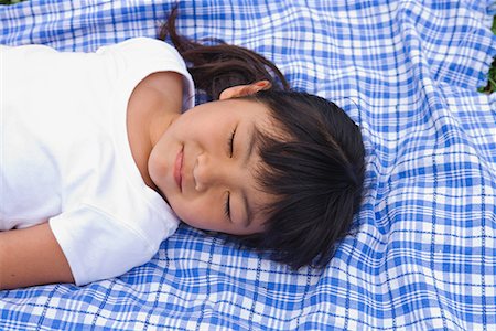 Girl sleeping on a blanket Stock Photo - Premium Royalty-Free, Code: 622-02354267