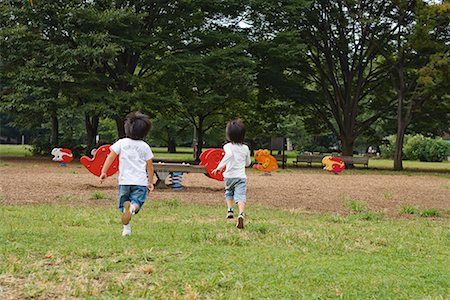 people running grass park - Two children running towards seesaw in a park Stock Photo - Premium Royalty-Free, Code: 622-02354268