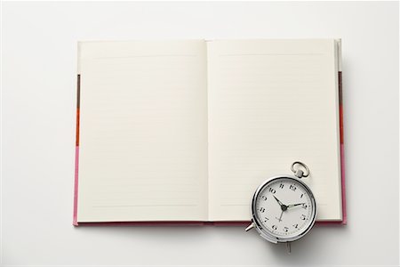 Empty notebook with clock Stock Photo - Premium Royalty-Free, Code: 622-02354356