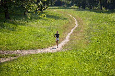 Teenage Girl Running on a Dirt Track Stock Photo - Premium Royalty-Free, Code: 622-02621572