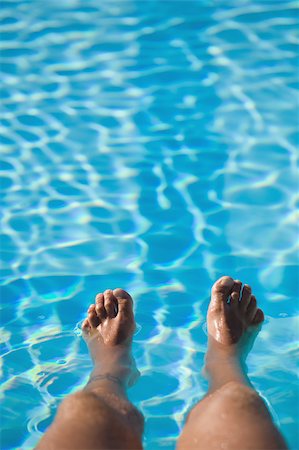 simsearch:622-02621605,k - Man with feet in swimming pool Stock Photo - Premium Royalty-Free, Code: 622-02621629