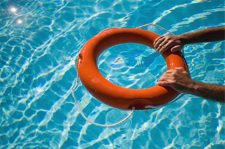 flotation - Man holding life ring floating in water Stock Photo - Premium Royalty-Free, Code: 622-02621630