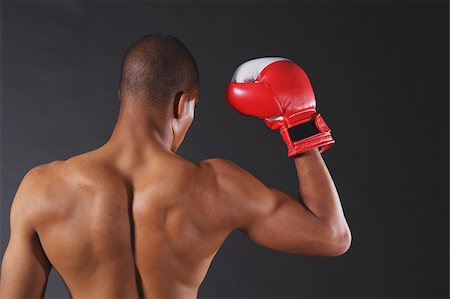 Boxer showing biceps with gloves Stock Photo - Premium Royalty-Free, Code: 622-02621640