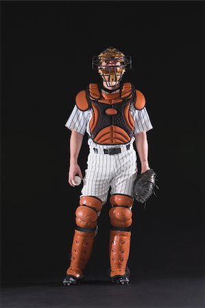 A baseball catcher standing with ball Fotografie stock - Premium Royalty-Free, Codice: 622-02621719