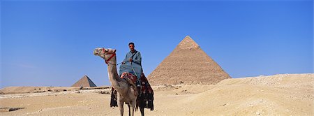 simsearch:622-02758110,k - Homme monté à dos de chameau dans le désert Photographie de stock - Premium Libres de Droits, Code: 622-02758092