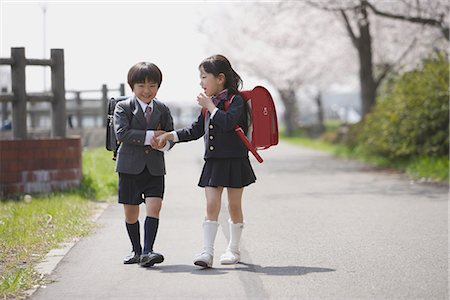 Schoolmate holding hands and walking together Stock Photo - Premium Royalty-Free, Code: 622-02758487