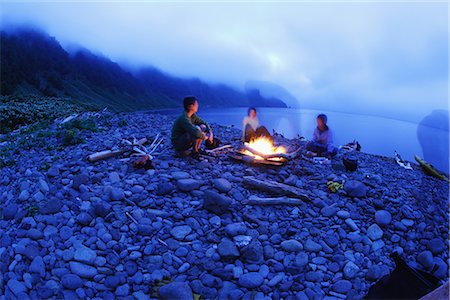 People Sitting Around Bonfire on Beach Stock Photo - Premium Royalty-Free, Code: 622-02759020