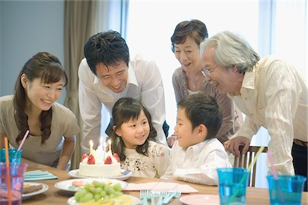 senior woman with cake - Three generation family celebrating birthday at home Stock Photo - Premium Royalty-Free, Code: 622-02759095