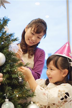 family hanging - Mother and daughter decorating xmas tree Stock Photo - Premium Royalty-Free, Code: 622-02759216