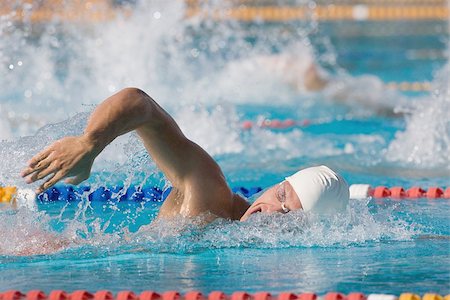 swimming goggles and cap - Young swimmer doing front crawl Stock Photo - Premium Royalty-Free, Code: 622-02913245