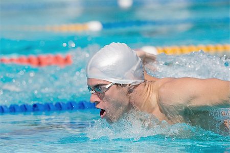 energy strokes - Young athlete doing butterfly stroke Stock Photo - Premium Royalty-Free, Code: 622-02913254