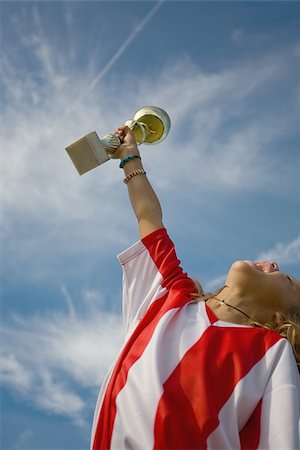 Soccer player cheering with trophy Stock Photo - Premium Royalty-Free, Code: 622-02913373