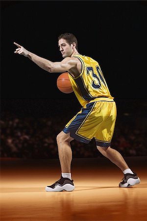 Young man playing basketball Stock Photo - Premium Royalty-Free, Code: 622-02913427