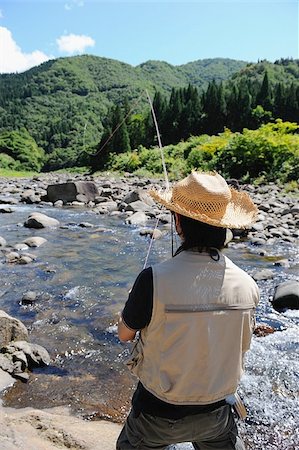 simsearch:622-02913459,k - Man with straw hat standing and fishing Fotografie stock - Premium Royalty-Free, Codice: 622-02913454