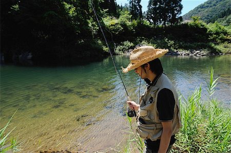 simsearch:622-02913456,k - Man with straw hat and holding fishing rod Fotografie stock - Premium Royalty-Free, Codice: 622-02913472
