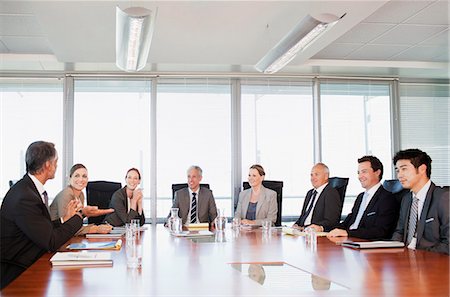 Boardroom Meeting Suits Not Looking At Camera Stock Photos