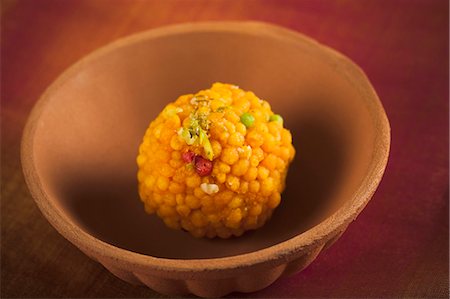 Close-up of a motichoor laddoo (a popular traditional Indian sweet) in a bowl Stock Photo - Premium Royalty-Free, Code: 630-06724459