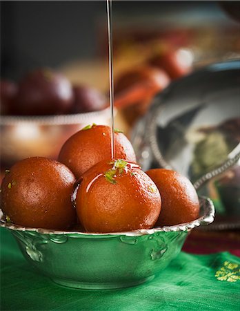 deepavali festival - Sugar syrup being poured on gulab jamuns in a bowl Stock Photo - Premium Royalty-Free, Code: 630-06724466