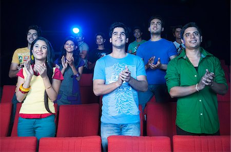 Youngsters applauding in a cinema hall Stock Photo - Premium Royalty-Free, Code: 630-06724534