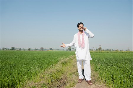 people of india - Farmer talking on a mobile phone in the field, Sonipat, Haryana, India Photographie de stock - Premium Libres de Droits, Code: 630-06724652