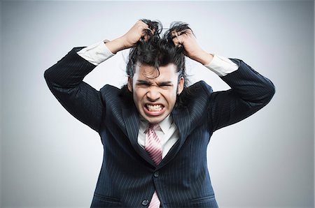 screaming portrait - Businessman pulling his hair in frustration Stock Photo - Premium Royalty-Free, Code: 630-06724728