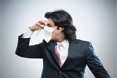 someone about to sneeze - Businessman blowing his nose Stock Photo - Premium Royalty-Free, Code: 630-06724732