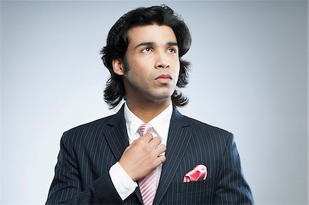 Close-up of a businessman adjusting his tie Foto de stock - Sin royalties Premium, Código: 630-06724743