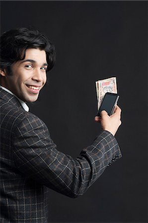 pictures of rich man holding money - Mobile banking Stock Photo - Premium Royalty-Free, Code: 630-06724758