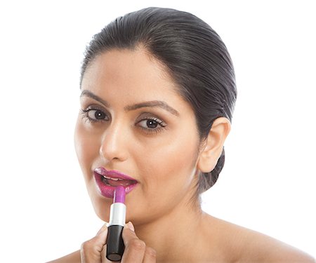 simsearch:640-02657383,k - Woman applying pink lipstick Stock Photo - Premium Royalty-Free, Code: 630-06724793