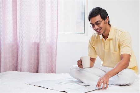 reading on bed - Bengali man reading a newspaper and having coffee Stock Photo - Premium Royalty-Free, Code: 630-06724886
