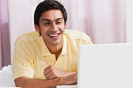 Bengali man using a laptop Stock Photo - Premium Royalty-Free, Code: 630-06724882