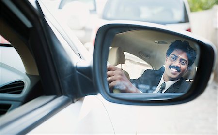 simsearch:630-06724909,k - Reflection of a South Indian businessman in the side view mirror of a car Photographie de stock - Premium Libres de Droits, Code: 630-06724910