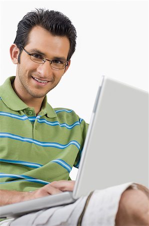 Portrait of a man using a laptop Stock Photo - Premium Royalty-Free, Code: 630-06721848