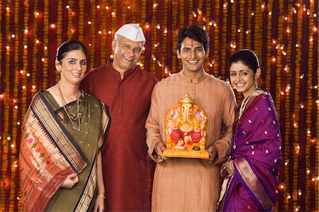 Portrait of a family holding an idol of lord Ganesha Stock Photo - Premium Royalty-Free, Code: 630-06721948