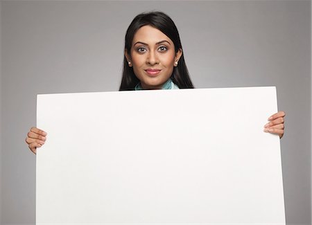 pretty indian woman image - Businesswoman showing a placard Stock Photo - Premium Royalty-Free, Code: 630-06722000