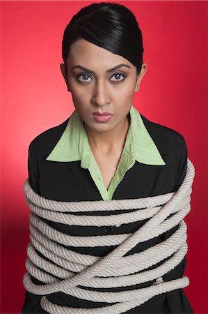 people in suit tied up - Portrait of a businesswoman tied up with rope Stock Photo - Premium Royalty-Free, Code: 630-06722027