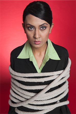 people tied up - Portrait of a businesswoman tied up with rope Foto de stock - Sin royalties Premium, Código: 630-06722027