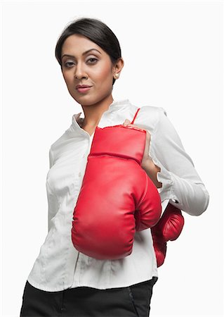 rat race - Portrait of a businesswoman carrying boxing gloves on her shoulder Stock Photo - Premium Royalty-Free, Code: 630-06722020