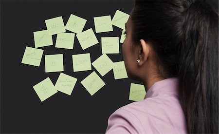 ponytail closeup back - Businesswoman looking at adhesive notes on a board Stock Photo - Premium Royalty-Free, Code: 630-06722075