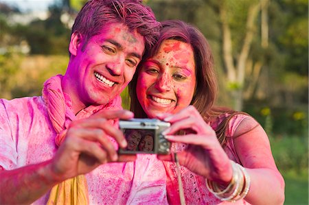 Couple taking a picture of themselves on Holi Stock Photo - Premium Royalty-Free, Code: 630-06722109