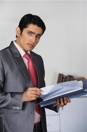 simsearch:630-06723037,k - Portrait of a businessman doing paperwork in an office Stock Photo - Premium Royalty-Free, Code: 630-06722213