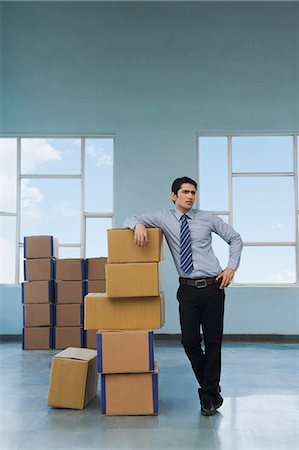 simsearch:630-06723037,k - Businessman with cardboard boxes in a warehouse Stock Photo - Premium Royalty-Free, Code: 630-06722227