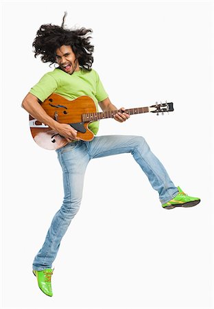 simsearch:400-06690896,k - Man jumping in the air while playing a guitar Stock Photo - Premium Royalty-Free, Code: 630-06722257