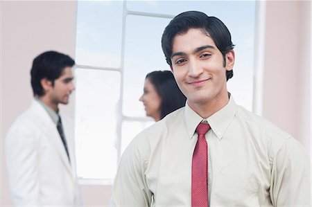 simsearch:630-06722386,k - Portrait of a businessman smiling Stock Photo - Premium Royalty-Free, Code: 630-06722366